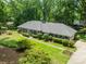 Aerial view of the home showing the lush lawn and landscaping, driveway, and mature trees at 532 Courtney Ln, Matthews, NC 28105