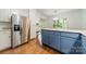 Updated kitchen features stainless steel appliances, granite counters, and stylish blue and white cabinetry at 532 Courtney Ln, Matthews, NC 28105
