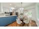 Open-concept kitchen and dining area with blue and white cabinetry and modern lighting fixtures at 532 Courtney Ln, Matthews, NC 28105