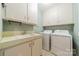 Practical laundry room equipped with a sink, storage cabinets, and modern washer and dryer at 532 Courtney Ln, Matthews, NC 28105