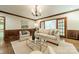 Living room with hardwood floors, fireplace, traditional mouldings, and neutral decor at 532 Courtney Ln, Matthews, NC 28105