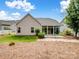 The house has a neatly maintained backyard and an attached sunroom at 581 Harrison Nw Dr, Concord, NC 28027