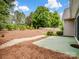 Large backyard featuring mature trees, lush landscaping and white picket fence at 581 Harrison Nw Dr, Concord, NC 28027