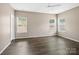 Spacious bedroom with hardwood floors and abundant natural light from three windows at 581 Harrison Nw Dr, Concord, NC 28027