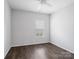 Clean, minimalist bedroom with ceiling fan and hardwood floors at 581 Harrison Nw Dr, Concord, NC 28027