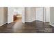 Primary bedroom with hardwood floors and doors to closet and ensuite bath at 581 Harrison Nw Dr, Concord, NC 28027
