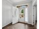 Bright foyer features an open door with decorative glass, hardwood floors, and neutral paint at 581 Harrison Nw Dr, Concord, NC 28027