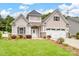 Charming home featuring stone accents, a two-car garage, manicured lawn and a covered front porch at 581 Harrison Nw Dr, Concord, NC 28027
