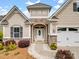 Inviting home exterior showcasing stone details, a two-car garage, and a well-manicured front yard at 581 Harrison Nw Dr, Concord, NC 28027