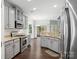 Open kitchen with stainless steel appliances and granite counters adjacent to dining room at 581 Harrison Nw Dr, Concord, NC 28027