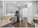 Kitchen with stainless steel appliances, granite countertops, and dark wood flooring at 581 Harrison Nw Dr, Concord, NC 28027