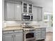 Kitchen with stainless steel appliances, granite counters, and gray cabinetry at 581 Harrison Nw Dr, Concord, NC 28027