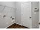 Functional laundry room with overhead shelving and convenient access door at 581 Harrison Nw Dr, Concord, NC 28027