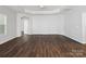 Living room with wood-look floors, bright white walls, tray ceiling, recessed lights, and lots of natural light at 581 Harrison Nw Dr, Concord, NC 28027
