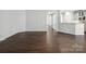 Spacious living room with wood-look floors, bright white walls and an open concept layout at 581 Harrison Nw Dr, Concord, NC 28027