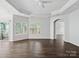 Open living room with tray ceilings, fan, dark hardwood floors and lots of natural light at 581 Harrison Nw Dr, Concord, NC 28027