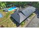 Aerial view of the property highlighting the pool, patio area, and modern metal roof at 6108 Phyliss Ln, Mint Hill, NC 28227