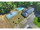 Aerial view showcasing a luxurious home with a pool, basketball court, lush landscaping, and inviting driveway at 6108 Phyliss Ln, Mint Hill, NC 28227