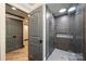 Gorgeous bathroom with glass enclosed shower, double doors, and modern design at 6108 Phyliss Ln, Mint Hill, NC 28227