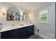 Bathroom features double vanities, framed mirrors, and decorative lighting fixtures at 6108 Phyliss Ln, Mint Hill, NC 28227