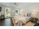 Relaxing bedroom with hardwood floors, a ceiling fan, and large windows providing lots of natural light at 6108 Phyliss Ln, Mint Hill, NC 28227