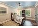 Welcoming bedroom with a ceiling fan, bright natural light, and built-in shelving at 6108 Phyliss Ln, Mint Hill, NC 28227