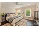 Bright bedroom with plantation shutters, ceiling fan, and stylish rug at 6108 Phyliss Ln, Mint Hill, NC 28227