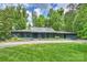 Beautiful ranch-style home with a metal roof, manicured lawn and professional landscaping at 6108 Phyliss Ln, Mint Hill, NC 28227