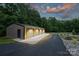 Large garage with room for multiple vehicles, surrounded by lush landscaping at 6108 Phyliss Ln, Mint Hill, NC 28227