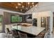 Chef's kitchen includes stainless appliances, large island, and views to the lush backyard at 6108 Phyliss Ln, Mint Hill, NC 28227