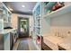 Well-organized laundry room with sink, shelving, and washer and dryer at 6108 Phyliss Ln, Mint Hill, NC 28227