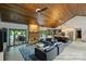 Open living space features vaulted ceilings, access to the pool, and a modern kitchen at 6108 Phyliss Ln, Mint Hill, NC 28227