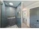 Modern walk-in shower features tiled walls, unique tile flooring, and glass enclosure at 6108 Phyliss Ln, Mint Hill, NC 28227