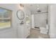 Bright bathroom with vanity, walk-in shower, and modern fixtures at 6301 Vernedale Rd, Charlotte, NC 28212
