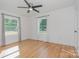 Bright bedroom with hardwood floors and natural light from two windows at 6301 Vernedale Rd, Charlotte, NC 28212
