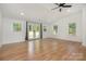Bright bonus room with hardwood floors, multiple windows for natural light and access to the backyard at 6301 Vernedale Rd, Charlotte, NC 28212