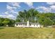 Lovely single-story home with a manicured lawn, painted brick, and a delightful bright teal front door at 6301 Vernedale Rd, Charlotte, NC 28212