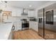 Bright kitchen featuring stainless steel appliances, white cabinets, and stylish subway tile backsplash at 6301 Vernedale Rd, Charlotte, NC 28212