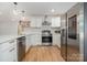 Well-lit kitchen showcasing modern appliances, white cabinets, and a sleek stainless steel refrigerator at 6301 Vernedale Rd, Charlotte, NC 28212