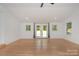 Spacious room with hardwood floors, and French doors leading to the backyard at 6301 Vernedale Rd, Charlotte, NC 28212