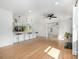 Open-concept living area with hardwood floors, kitchen island, fireplace, recessed lights and ceiling fan at 6301 Vernedale Rd, Charlotte, NC 28212