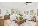 Spacious living room with a beamed ceiling, hardwood floors, and comfortable seating arrangement at 6301 Vernedale Rd, Charlotte, NC 28212