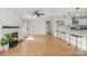 Open living space featuring hardwood floors, fireplace, kitchen island and recessed lighting throughout at 6301 Vernedale Rd, Charlotte, NC 28212
