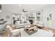 Bright living room featuring hardwood floors, a fireplace, and comfortable seating in neutral colors at 6301 Vernedale Rd, Charlotte, NC 28212