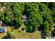 Aerial view of home nestled among lush trees, with expansive backyard offering privacy at 6766 Little Mountain Rd, Sherrills Ford, NC 28673