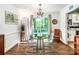 Bright dining area featuring hardwood floors, stylish chandelier, and sliding glass doors to a private deck at 6766 Little Mountain Rd, Sherrills Ford, NC 28673