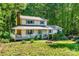 Inviting two-story home with a charming covered porch perfect for relaxing and enjoying the surrounding greenery and front yard at 6766 Little Mountain Rd, Sherrills Ford, NC 28673