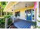 Welcoming front porch featuring a blue door with wreath, a rocking chair, and charming details at 6766 Little Mountain Rd, Sherrills Ford, NC 28673