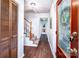 Inviting entryway with hardwood floors, staircase, and decorative front door at 6766 Little Mountain Rd, Sherrills Ford, NC 28673