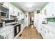 Functional kitchen with white cabinets, tiled floors, and an easy access to the dining and living areas at 6766 Little Mountain Rd, Sherrills Ford, NC 28673